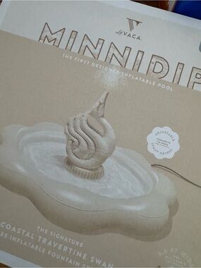 Minnidip Coastal Travertine Swan inflatable fountain sprinkler.